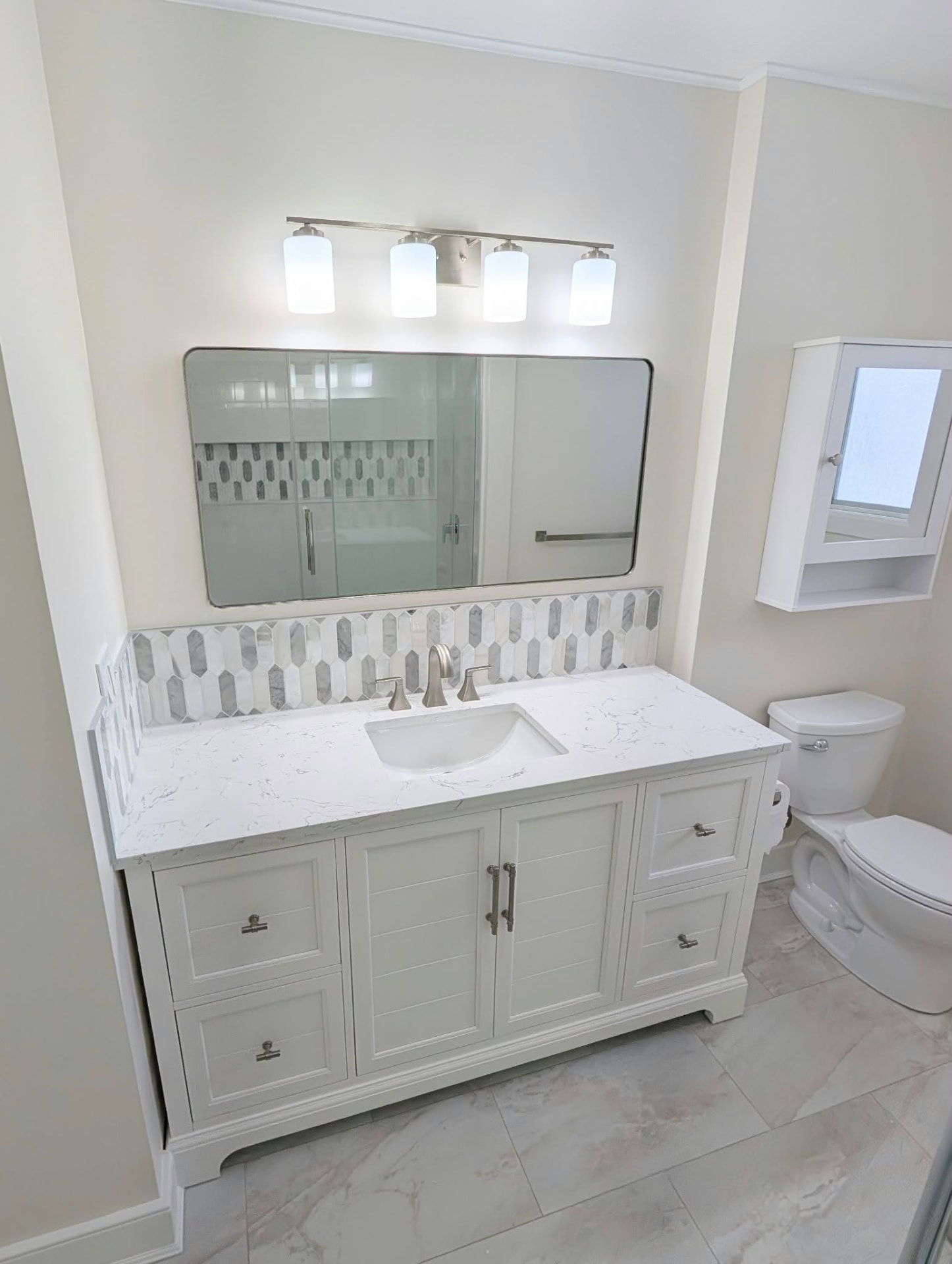 Bathroom vanity with quartz top and marble mosaic backsplash
