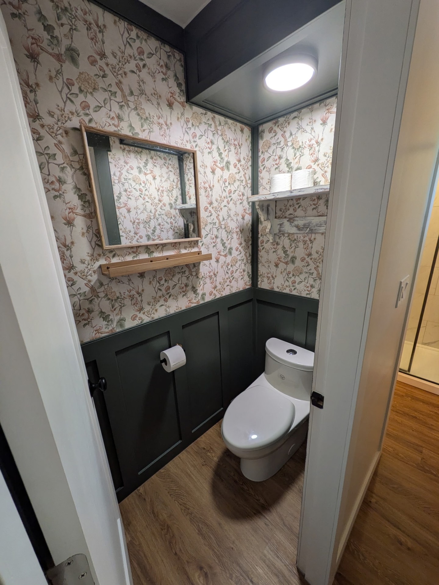 Powder room remodel with wainscoting and floral wallpaper